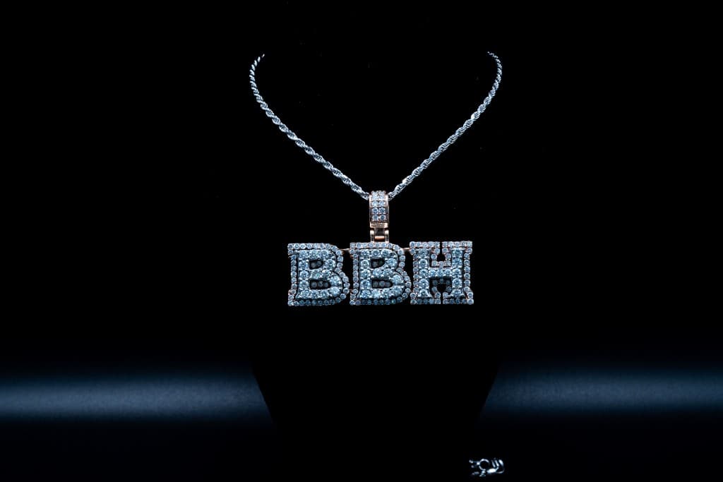 Custom diamond-set letter pendant on a gold rope chain